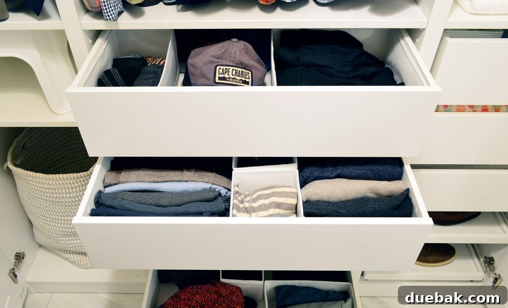 John's drawers pulled open, revealing the organized interior with IKEA Pax divider systems.