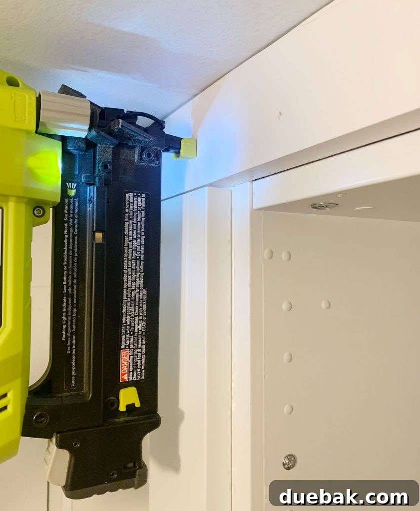 Nailing the second board to the IKEA Pax closet system to achieve a seamless built-in appearance.