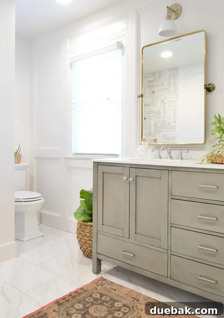 Elevate Your Walls with Decorative Molding 11 Bathroom Makeover with Gray Vanity, Brass Mirror, and Decorative Wall Molding
