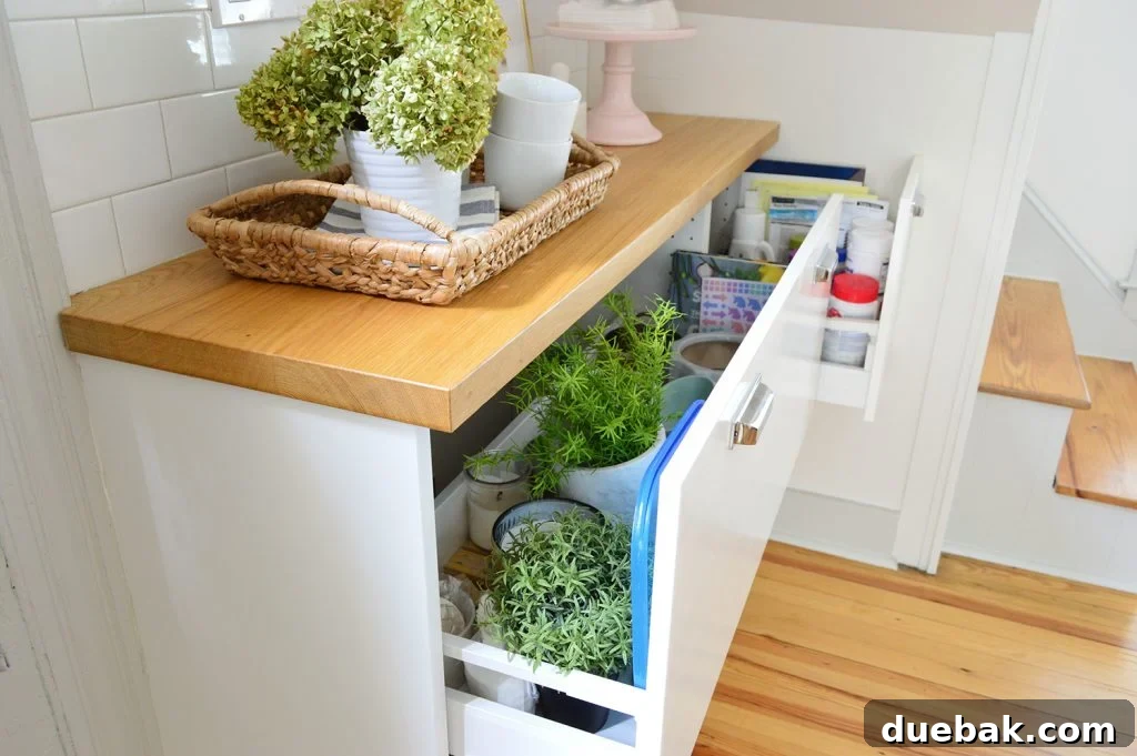 Open shallow kitchen cabinet drawers used for general household storage