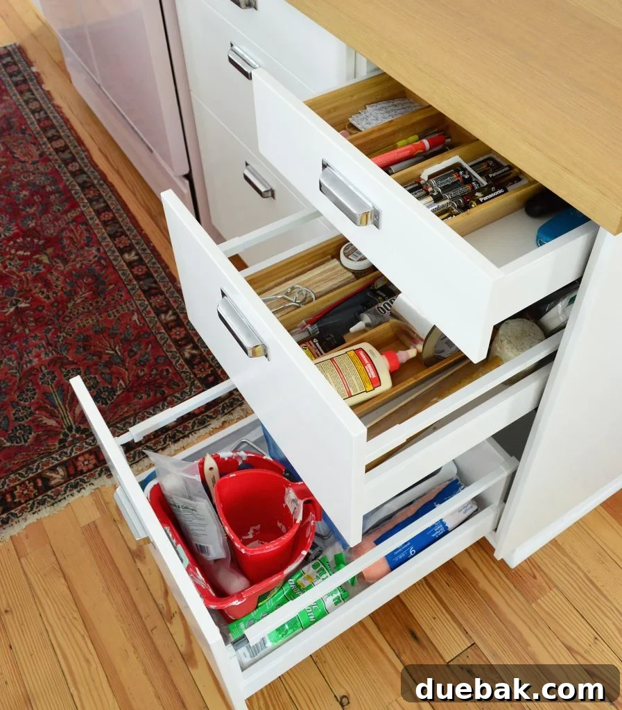 Kitchen drawer organized with various household tools and DIY supplies