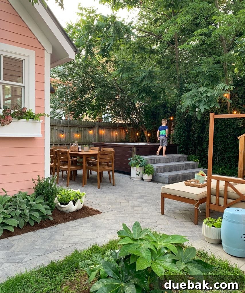 Our Warm-Weather Downsize: Finding Freedom in a Smaller Home 12 Lush, green backyard of a charming small house, reflecting a simplified lifestyle