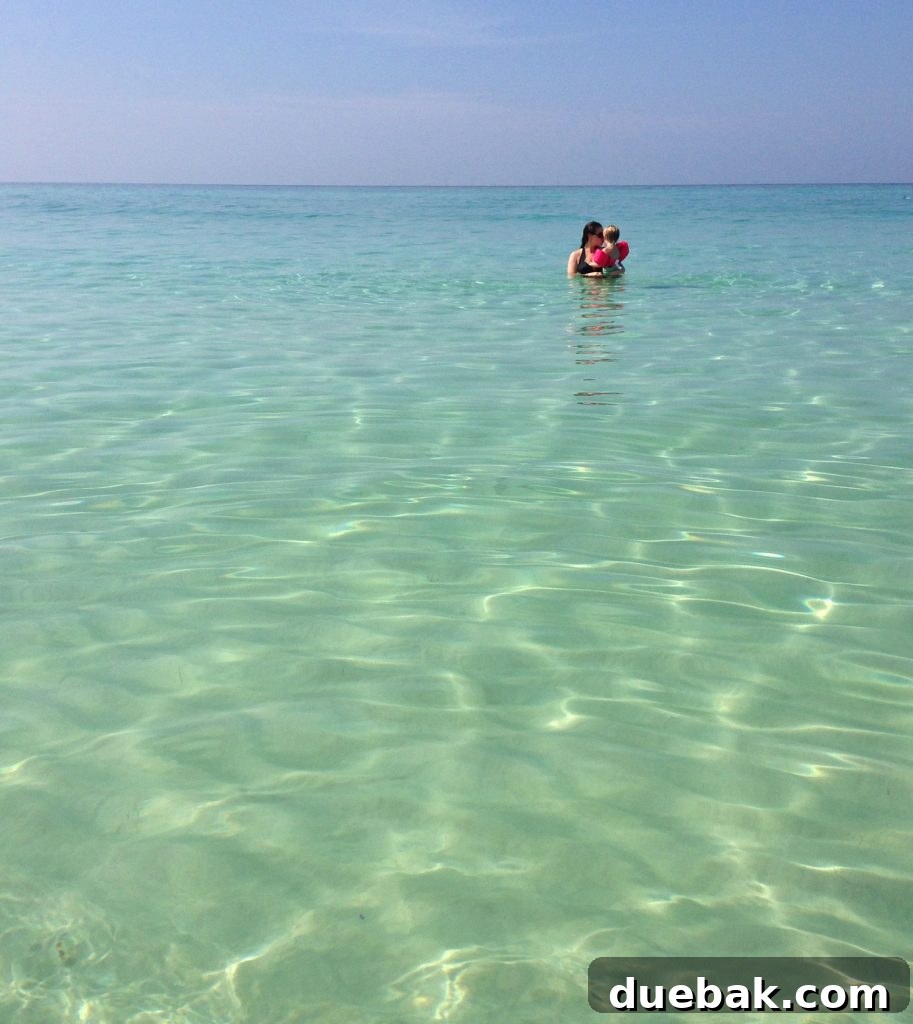 Our Warm-Weather Downsize: Finding Freedom in a Smaller Home 3 Scenic view of a pristine beach with blue-green water