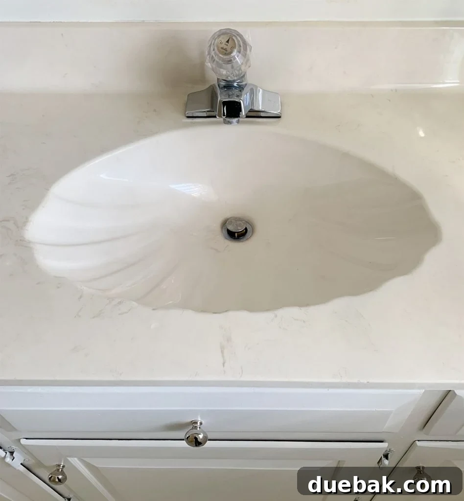 Our Warm-Weather Downsize: Finding Freedom in a Smaller Home 9 Newly renovated modern bathroom with unique seashell sinks