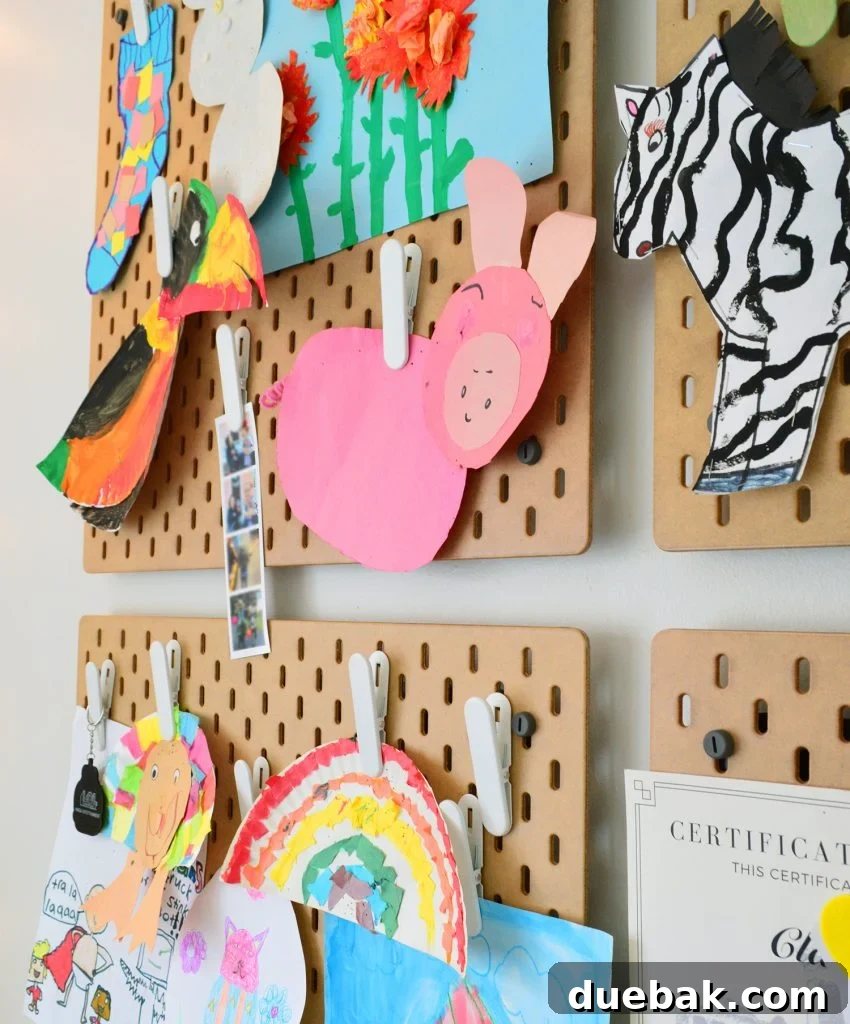 Ikea Skadis Pegboard Organizer With Kids Artwork Clipped Up For Display
