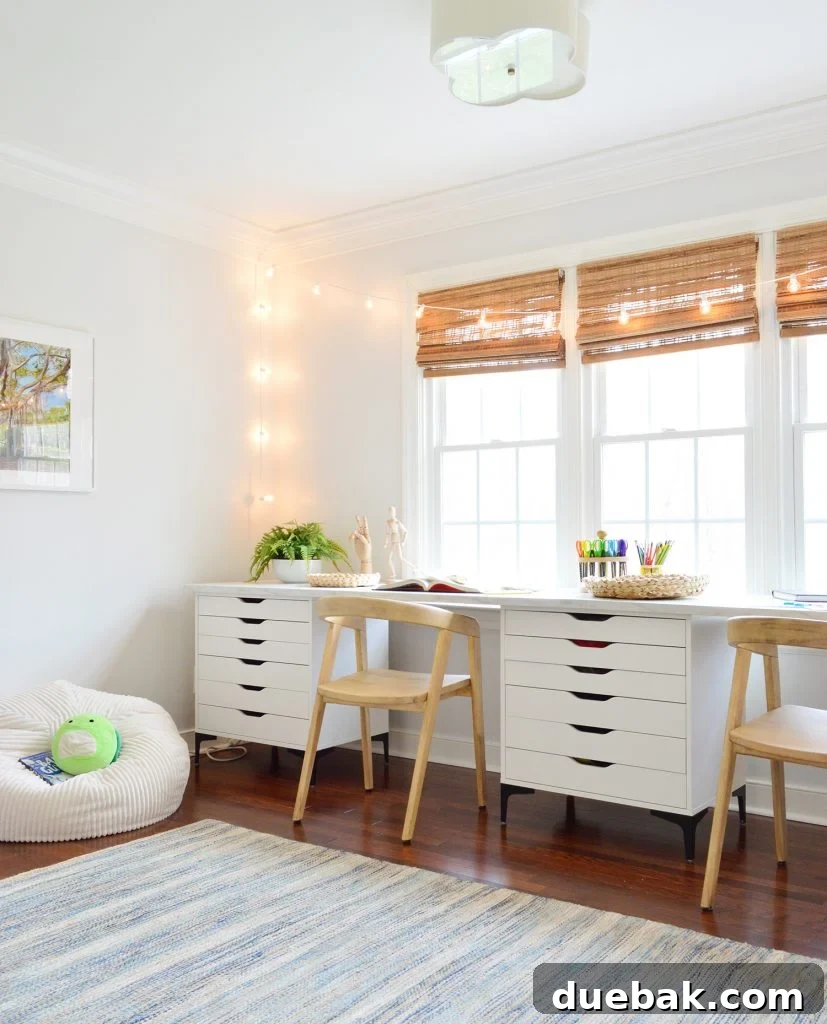 Kids Art Room With Two Wood Chairs Along Long Art Desk Workspace With String Lights