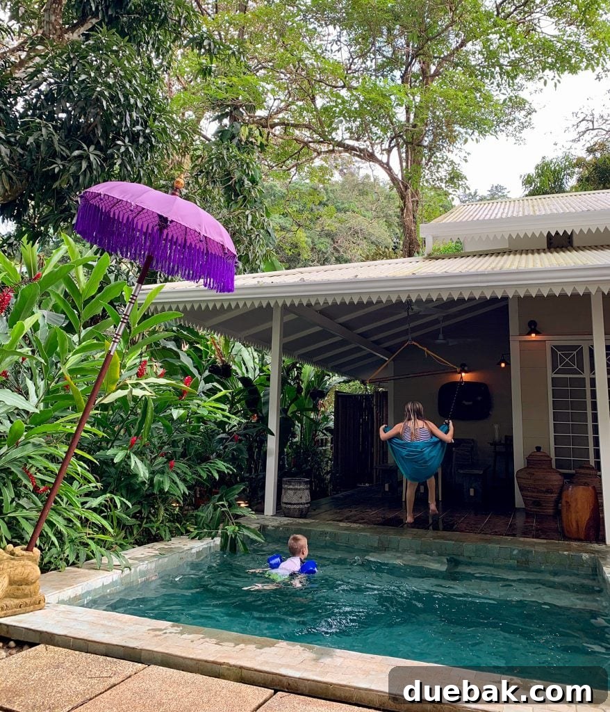 Our Petite Beach House: Maximizing Coastal Charm 5 A small, inviting swimming pool with lush tropical landscaping, hinting at a cozy, private backyard oasis.