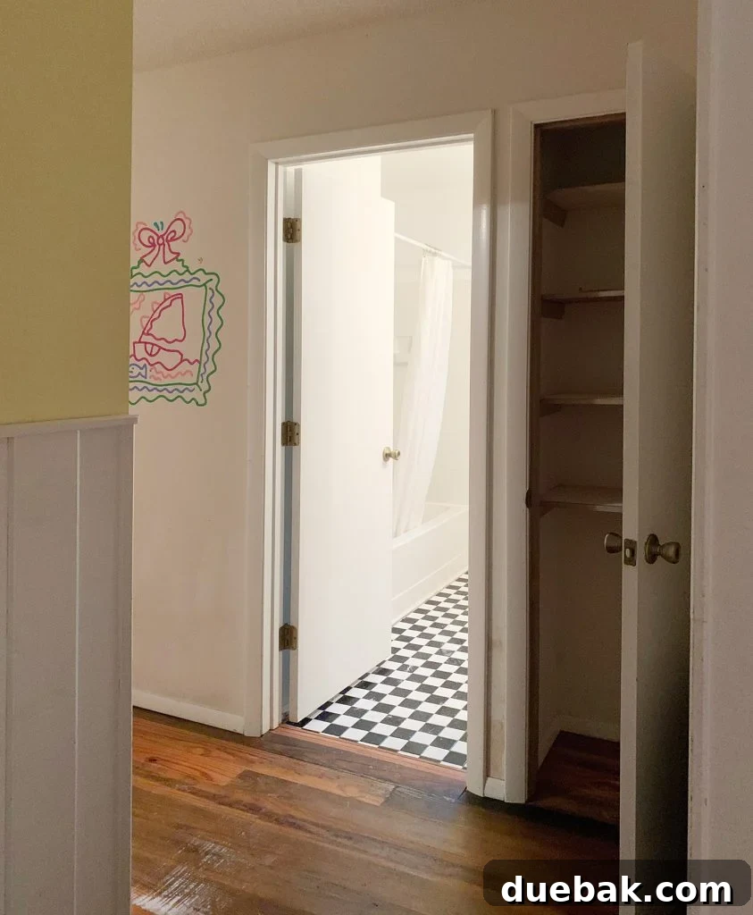 Hallway leading to the bathroom and linen closet, before renovation.