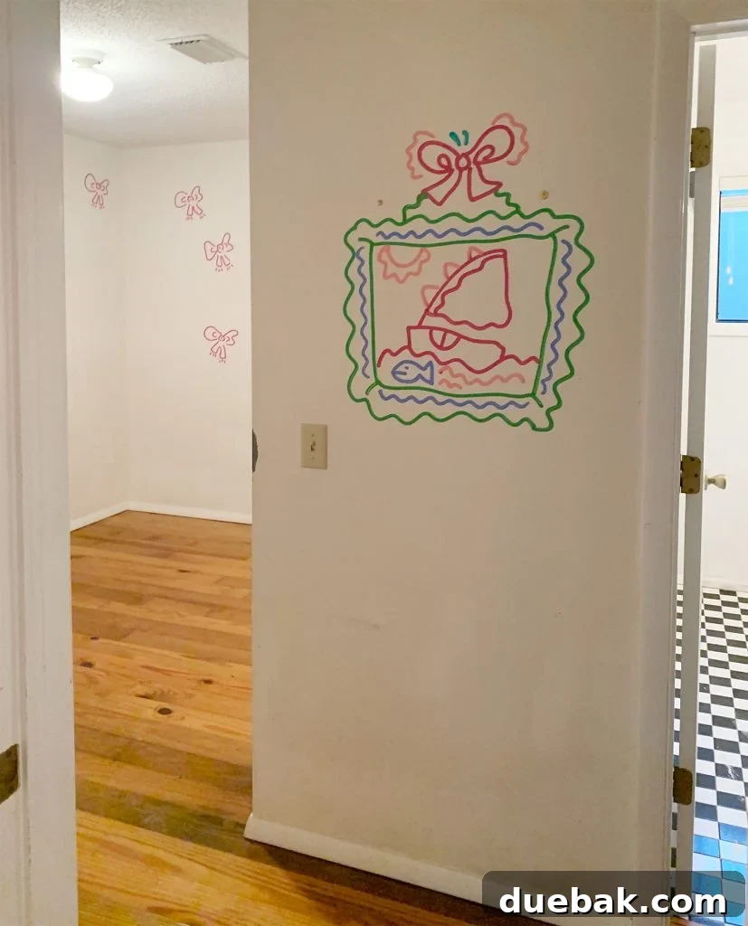 Former laundry room, now son's bedroom, with small drawings on the wall.