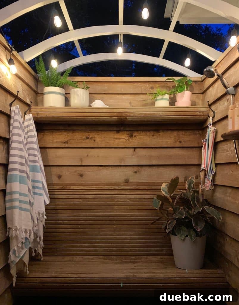 Outdoor shower at night, beautifully lit by the string lights, creating a serene atmosphere.
