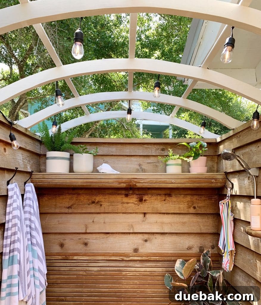 Outdoor shower showing the view upwards, with a distant balcony visible through the open roof.