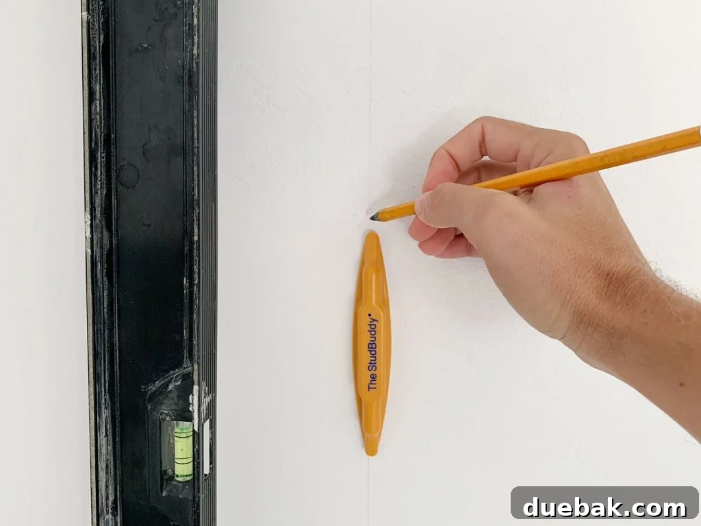 Hand Marking Vertical Level Line On Wall Using StudBuddy Stud Finder