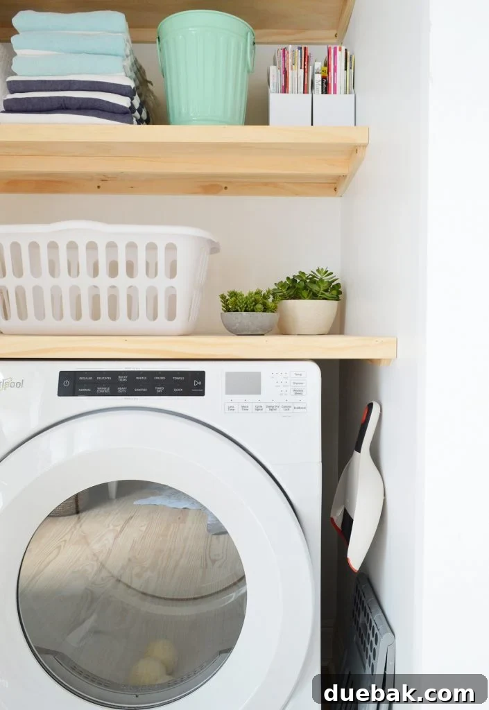 Profile view of laundry closet with DIY wood floating shelves 