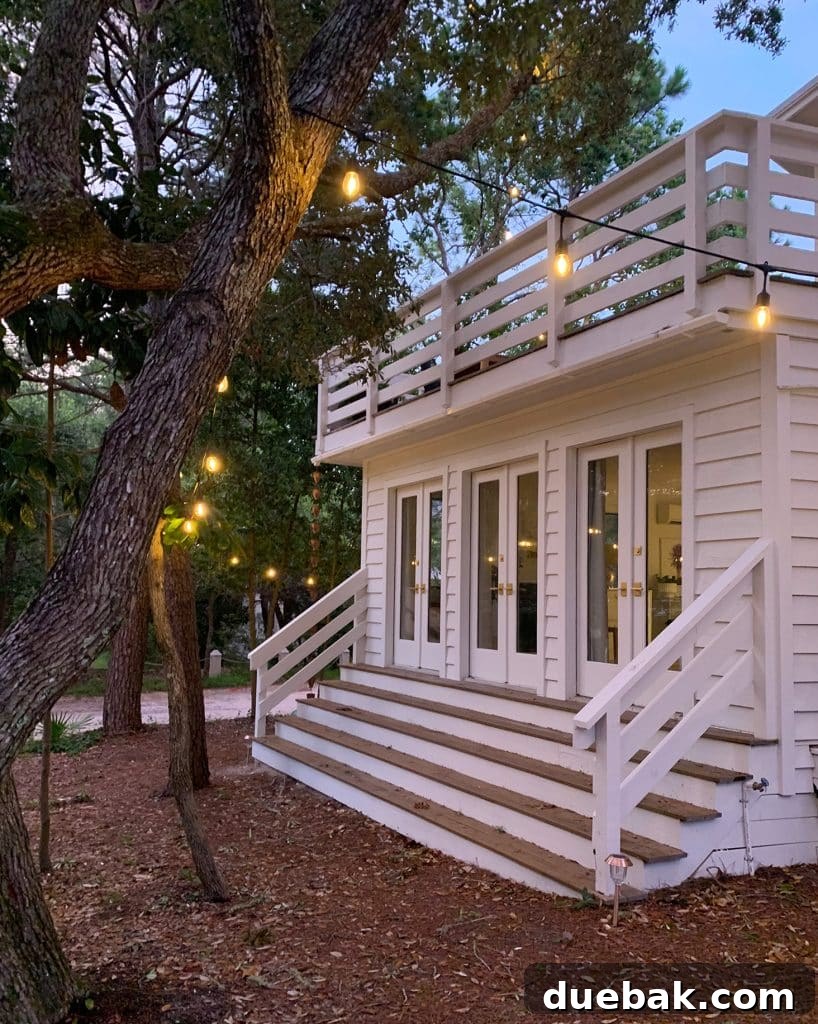 Bedroom Refresh: What's New and What's Next 12 View of bedroom exterior at dusk, showing stairs leading down to the yard with string lights