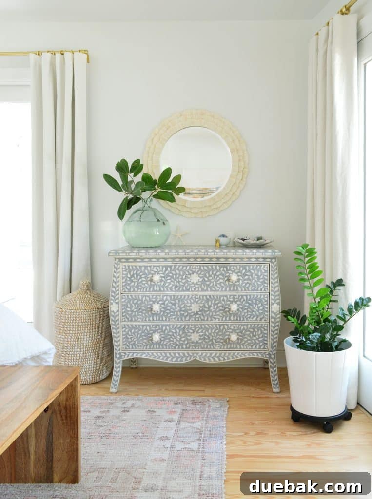 Bedroom Refresh: What's New and What's Next 5 Stylish primary bedroom corner with a long dresser, mirror, and plant, bathed in natural light