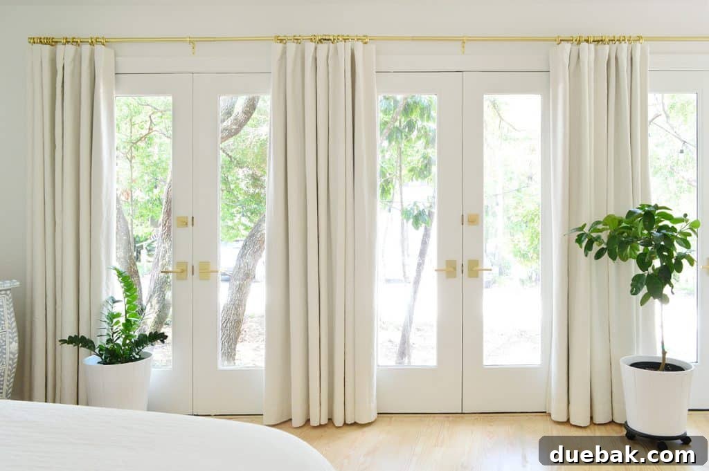 Bedroom Refresh: What's New and What's Next 9 Close-up of brass curtain rod and rings with neutral-colored blackout curtains
