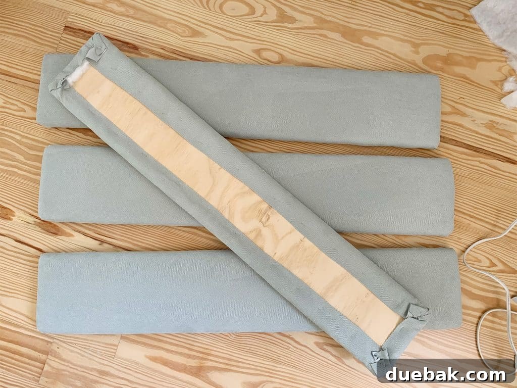 Craft Your Own Channel Tufted Headboard 14 All four upholstered channel panels laid out, ready for assembly into the headboard.