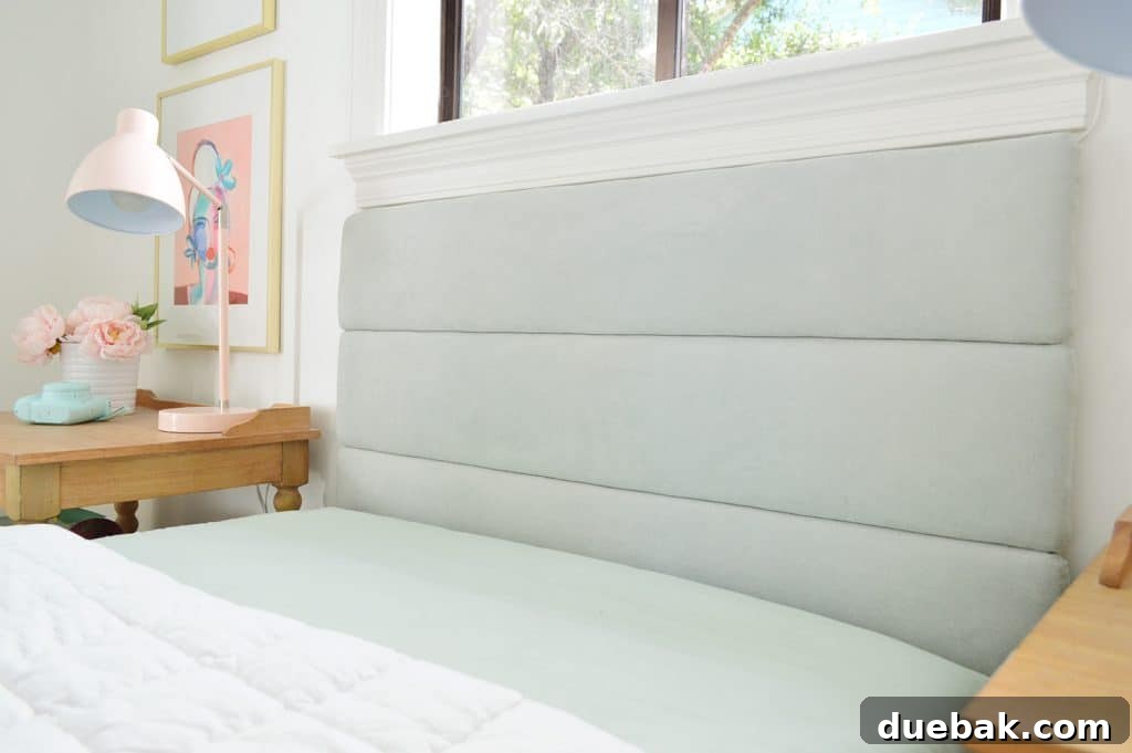 Craft Your Own Channel Tufted Headboard 16 The installed headboard above the bed, demonstrating how it integrates into the room's design.