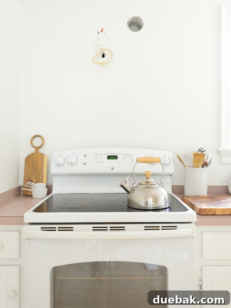 5 Speedy Kitchen Makeovers 18 Empty Wall Space Above White Stove In Minimal White Kitchen