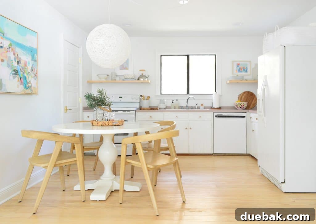 5 Speedy Kitchen Makeovers 8 Minimal White Kitchen With White Globe Woven Chandelier over Pedestal Table