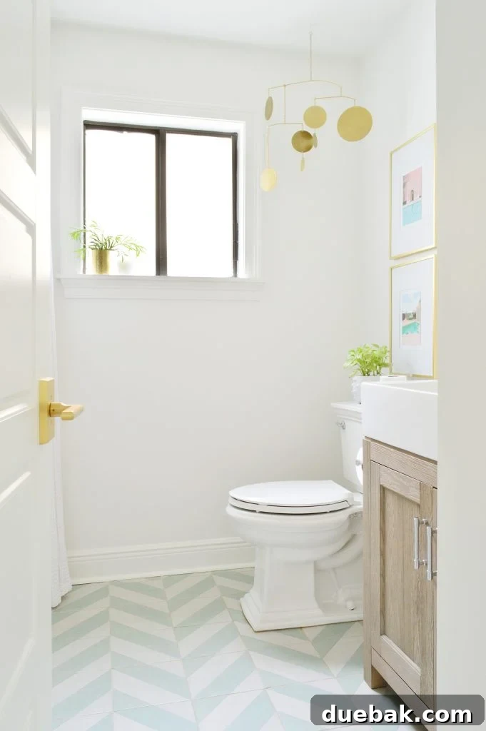 Our Single Bathroom Transformation: Before and After 5 A bright, modern bathroom with geometric floor tiles and a minimalist design.