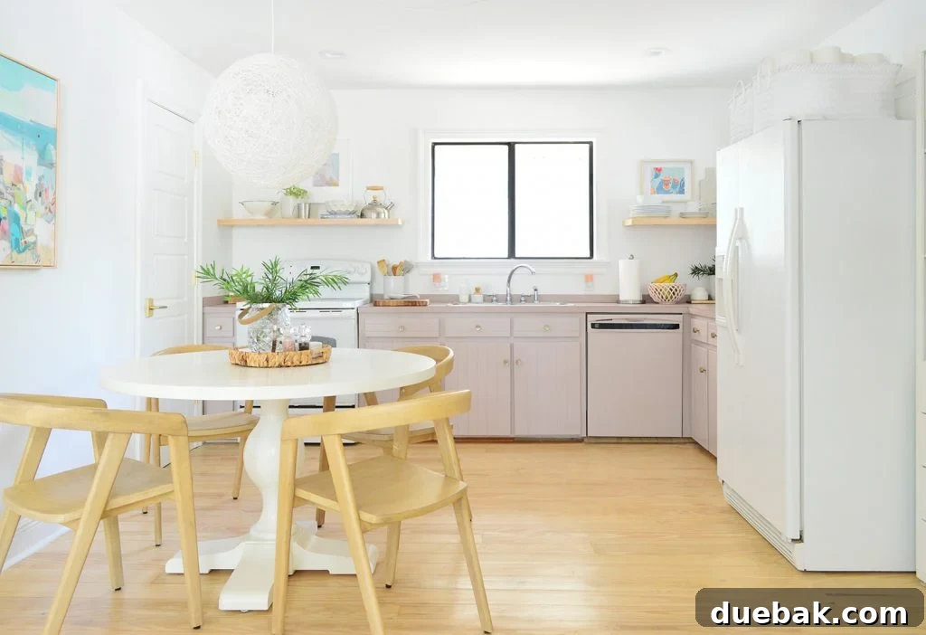 Minimal Kitchen With Mauve Painted Cabinets And Pedestal Table