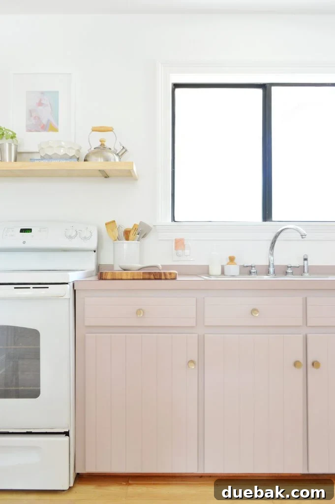 Small kitchen with added shelving next to the refrigerator