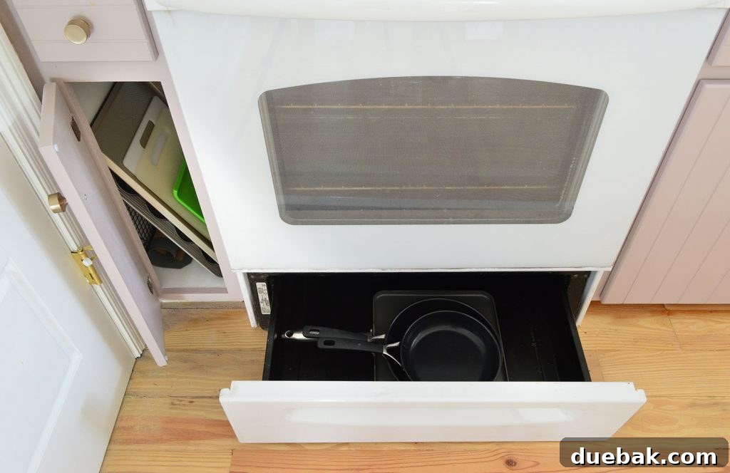Skinny cabinet organized with cutting boards, a cookie sheet, and a muffin tin