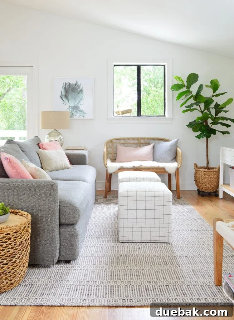 Installing Serena & Lily's Statement Chandelier 9 Family Room With Couch Striped Ottomans And Woven Bench, highlighting the cohesive and comfortable seating arrangement.
