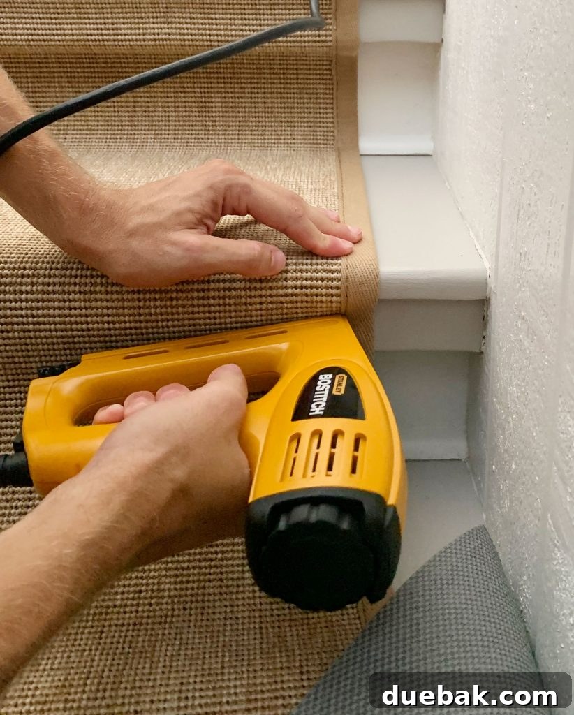 Step Up Your Style: Sisal Stair Runners 13 Yellow Electric Stapler Attaching Runner Under Lip Of Stair Tread