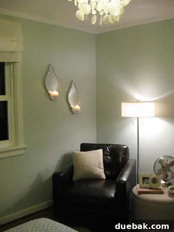 Staggered candle sconces beautifully installed on a bedroom wall