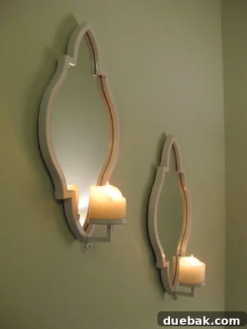 Intricate detail of a reflective candle sconce on the wall