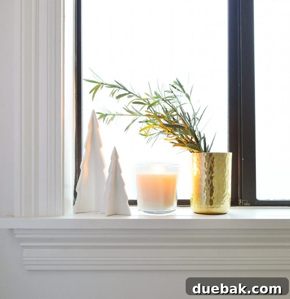 White Ceramic Trees With Candle And Gold Vase On Bathroom Window Sill
