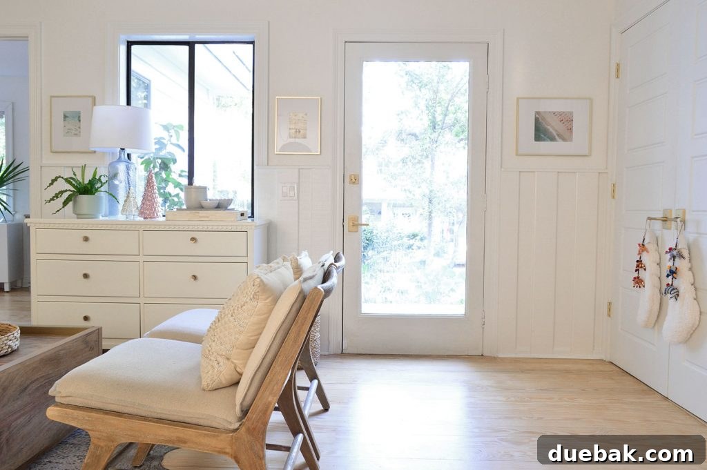 Open floor space behind the seating area, near the front door and laundry closet