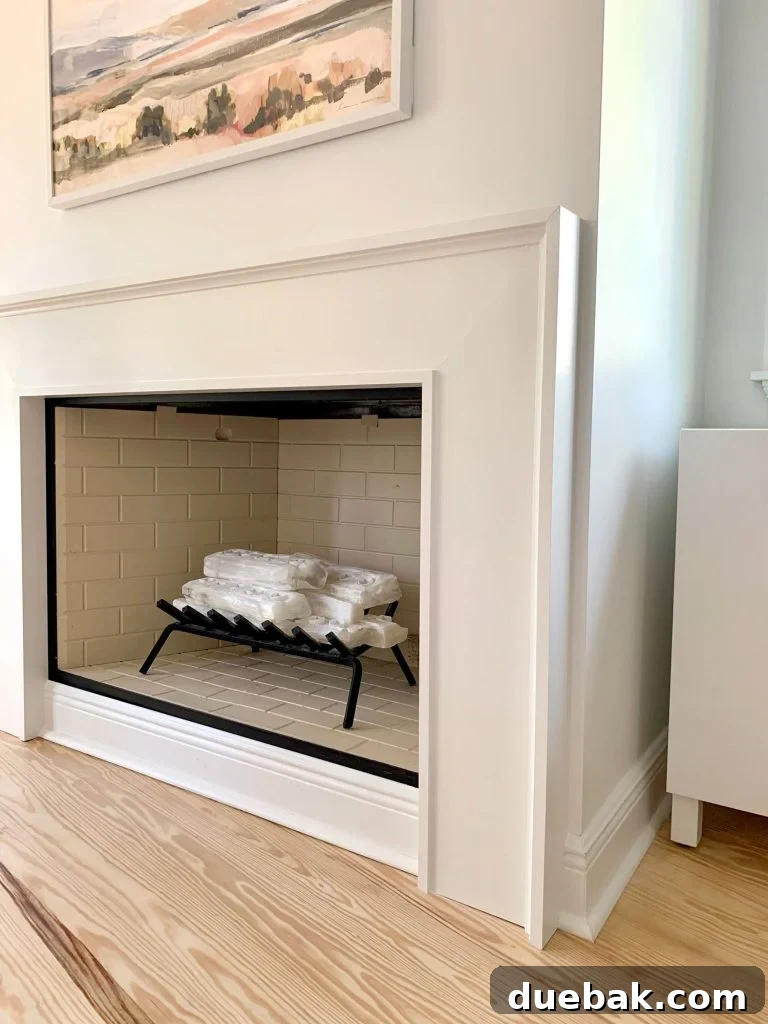 Closer view of fireplace surround showing about an inch of drywall between it and corner of wall