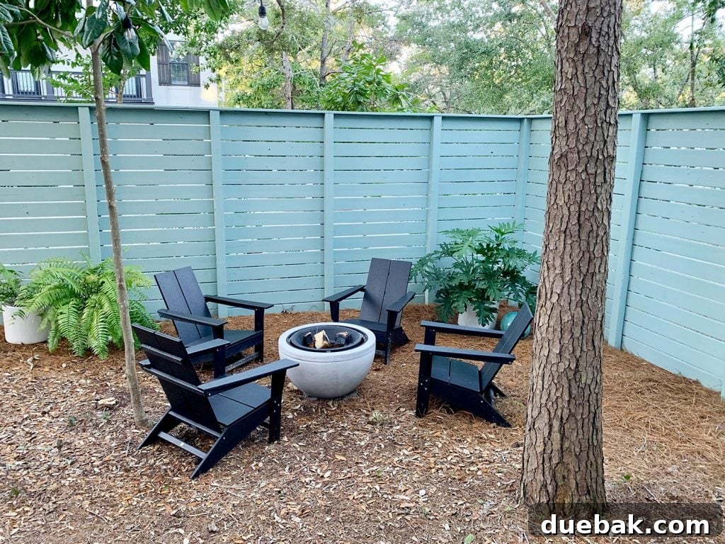 Side yard with blue-green painted horizontal fence