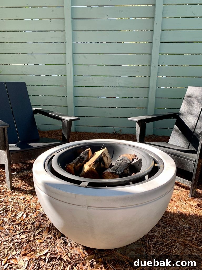 Detail of faux stone fire pit with burnt logs in it
