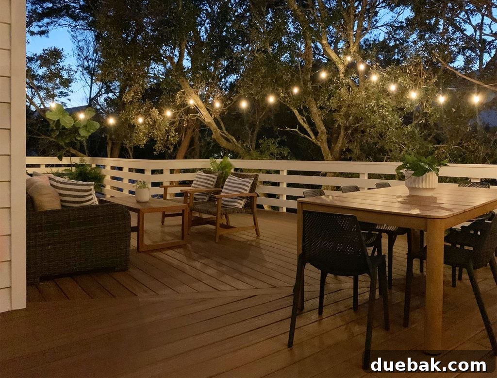 Nighttime View Of Large Deck With String Lights And Dining Area