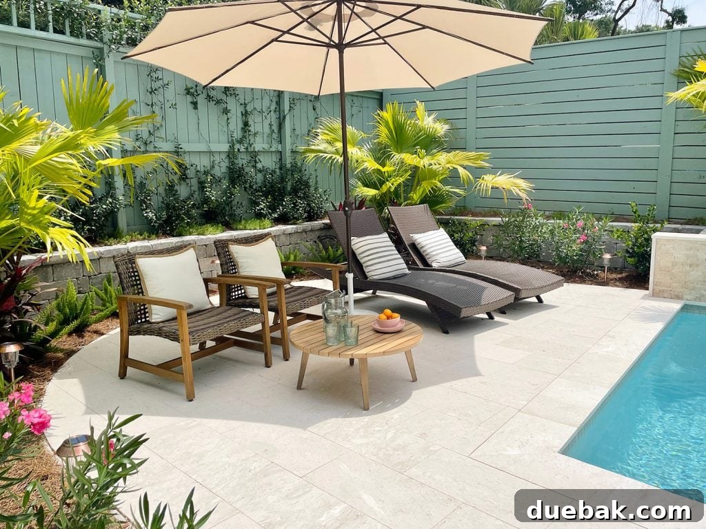 Round pool patio area surrounded by tropical plantings Chinese palms oleander jasmine stonecrop foxtail ferns, enhancing the serene ambiance.
