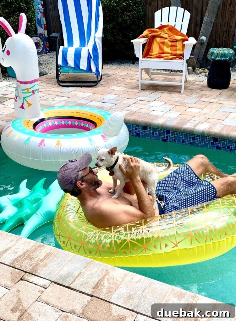Burger standing on John in pineapple pool float