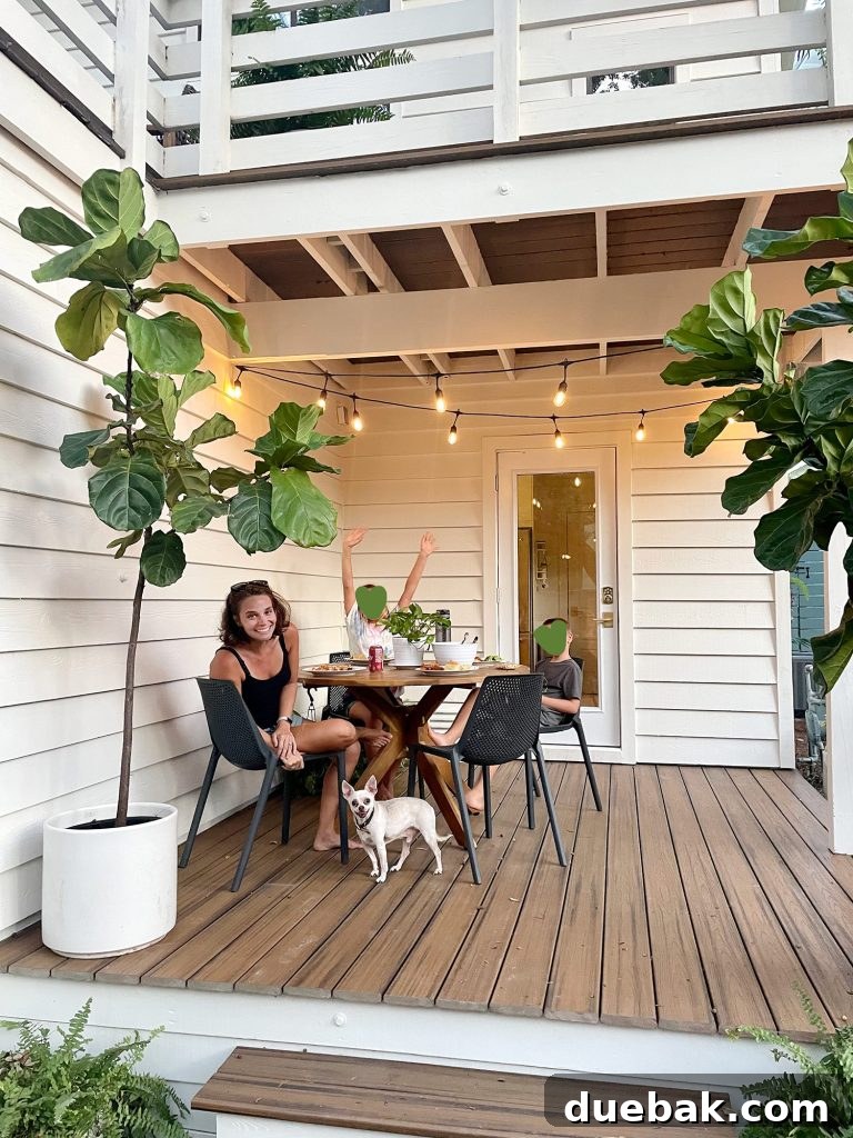 Family sitting on patio table with Burger standing under table