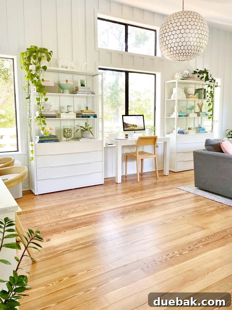 Two Ikea Fjalkinge Bookcases Flanking Office Deck In Middle Of Modern White Upstairs Family Room With Large Windows 
