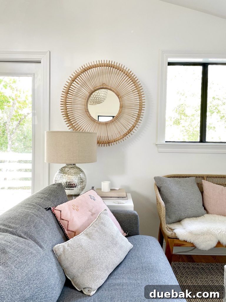 Round Woven Mirror Behind Side Table Next to Family Room Couch