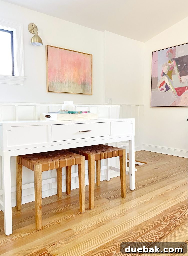 Console Table In Upstairs Modern Family Room With Leather Benches And Framed Painting Artwork In Background
