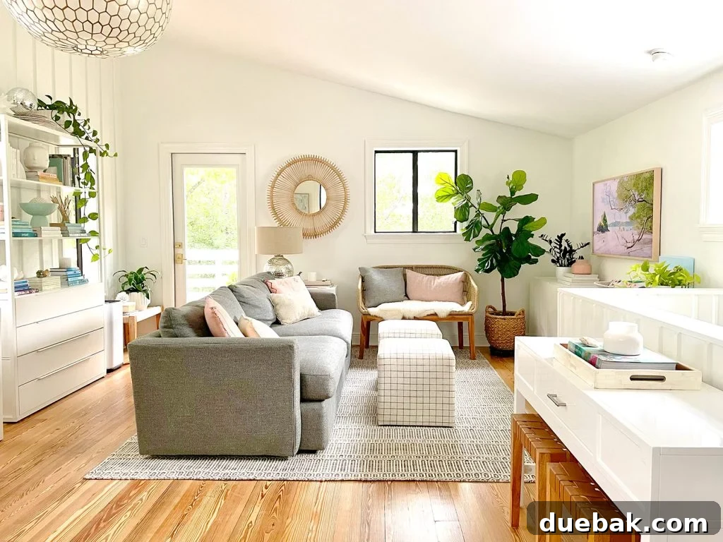 Wide View Of Upstairs Family Room With White Walls And Vaulted Ceiling With Plants