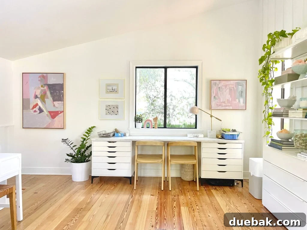Kids Art Desk Under Window In Open Modern White Family Room With Faulted Ceilings And Artwork