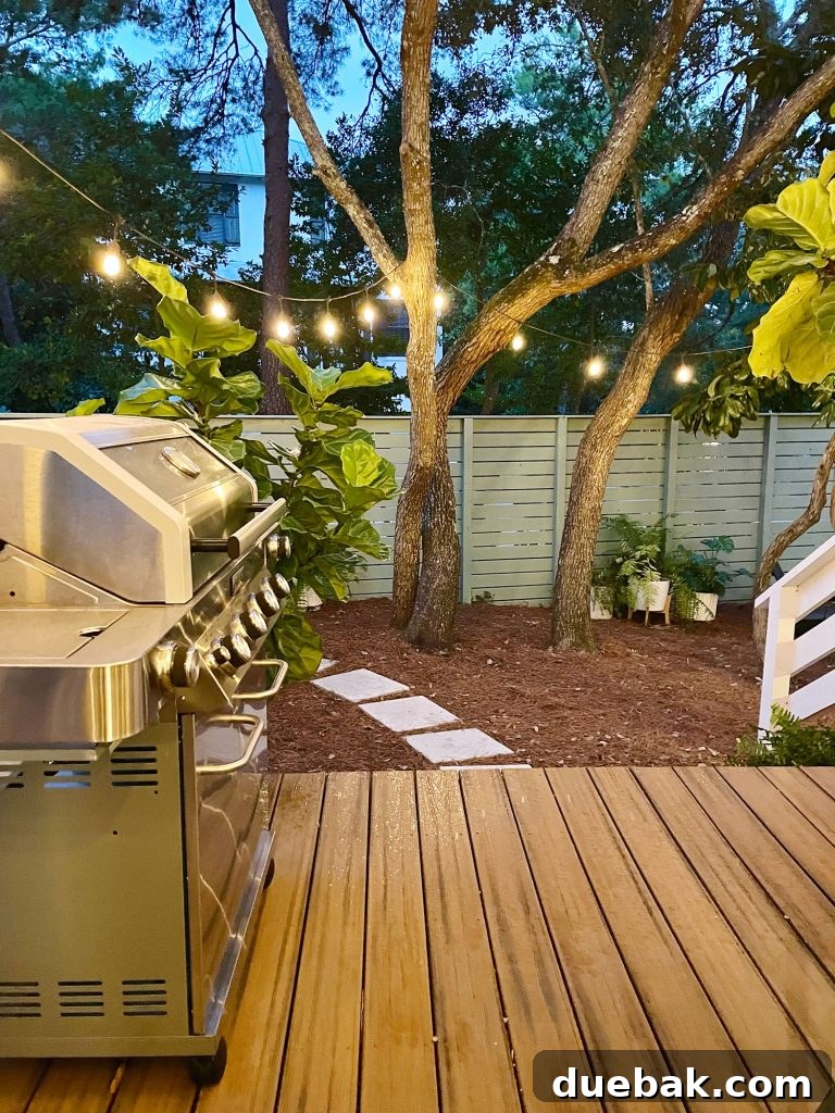 Night view from the porch, with string lights softly glowing in the side yard, creating a tranquil and magical atmosphere