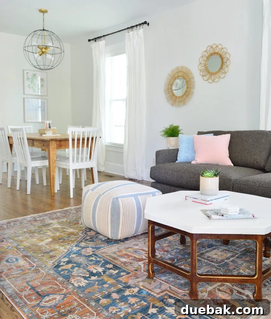 Rug Sizing Guide and Our Favorite Magic Rug Pick 9 Neutral Traditional Rug With Crate And Barrel Sofa And Pouf With Dining In Background