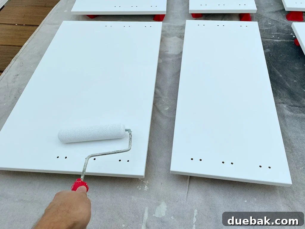 Applying Primer To Cabinet Door With Small Foam Roller