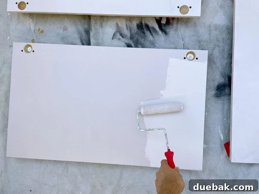 Applying Pink Paint To Ikea Kitchen Cabinet Doors With Small Foam Roller